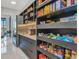 Spacious butler's pantry with stainless fridge, quartz countertops, and abundant shelf storage at 19 Sabal Dr, Punta Gorda, FL 33950