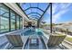 This elegant screened pool and patio has canal views and an attached spa at 19 Sabal Dr, Punta Gorda, FL 33950