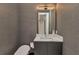 Stylish powder room with sleek vanity, elegant mirror, and modern fixtures at 19 Sabal Dr, Punta Gorda, FL 33950