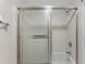 Full bathroom with white tiled walls and shower at 19505 Quesada Ave # A204, Port Charlotte, FL 33948