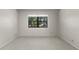 This carpeted bedroom has one large window at 19505 Quesada Ave # A204, Port Charlotte, FL 33948