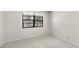 This carpeted bedroom has one large window at 19505 Quesada Ave # A204, Port Charlotte, FL 33948