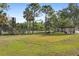 Expansive community space with shelter, benches, and lush green lawn is fenced for safety and recreation at 19505 Quesada Ave # A204, Port Charlotte, FL 33948