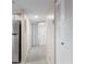 Hallway showing several doors with access to a bathroom and a laundry room at 19505 Quesada Ave # A204, Port Charlotte, FL 33948