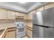 This kitchen features white appliances, light countertops, and ample cabinet space at 19505 Quesada Ave # A204, Port Charlotte, FL 33948