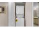 Hallway showing a laundry room with a stackable washer and dryer at 19505 Quesada Ave # A204, Port Charlotte, FL 33948