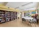 Community library featuring bookshelves, tables, and a TV, perfect for reading and gatherings at 19505 Quesada Ave # A204, Port Charlotte, FL 33948