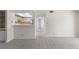 Spacious living room with neutral carpet and a view into the kitchen at 19505 Quesada Ave # A204, Port Charlotte, FL 33948