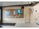 Lounge area with bulletin boards, wall clock, and door access for community events at 19505 Quesada Ave # A204, Port Charlotte, FL 33948
