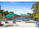 A serene outdoor patio features lake views, comfortable seating, and shaded umbrellas at 19505 Quesada Ave # A204, Port Charlotte, FL 33948