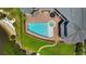 Aerial view of the backyard pool, spa and patio of this luxury waterfront home at 2107 4Th Street W Ct, Palmetto, FL 34221