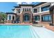Expansive backyard featuring a sparkling pool and spa, stone accents, and picturesque waterfront views at 2107 4Th Street W Ct, Palmetto, FL 34221