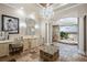 Luxurious bathroom with stone floors, vanity, tub, and natural light from the atrium at 2107 4Th Street W Ct, Palmetto, FL 34221