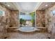 Stylish bathroom with a tub, stone walls, and a large window for natural light at 2107 4Th Street W Ct, Palmetto, FL 34221
