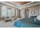 Bright and airy bedroom featuring a chandelier, large windows, and a sitting area with a plush sofa at 2107 4Th Street W Ct, Palmetto, FL 34221
