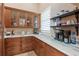 Classic butler's pantry boasts wood cabinets, marble counters, and well-organized shelving perfect for hosting at 2107 4Th Street W Ct, Palmetto, FL 34221