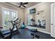 Well-equipped exercise room with treadmills, weights, and a mirrored wall for home fitness at 2107 4Th Street W Ct, Palmetto, FL 34221