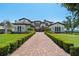 Stunning estate featuring a long brick driveway and meticulously manicured landscaping at 2107 4Th Street W Ct, Palmetto, FL 34221