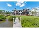 Stunning waterfront estate with a private dock, lush lawn, and a luxurious pool in the backyard at 2107 4Th Street W Ct, Palmetto, FL 34221