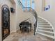 Grand foyer with a spiral staircase, piano, and tiled floors create a dramatic entry at 2107 4Th Street W Ct, Palmetto, FL 34221