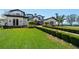 An expansive green lawn runs alongside the brick drive leading up to the beautiful residence at 2107 4Th Street W Ct, Palmetto, FL 34221