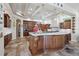 Gourmet kitchen with custom wood cabinets, granite countertops, and a large island at 2107 4Th Street W Ct, Palmetto, FL 34221