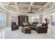 Spacious living room with coffered ceilings, leather furniture, and an abundance of natural light at 2107 4Th Street W Ct, Palmetto, FL 34221