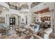 Elegant living room featuring soaring ceilings, stone floors, and sophisticated decor at 2107 4Th Street W Ct, Palmetto, FL 34221