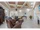 Spacious living room with coffered ceilings, fireplace, and leather furniture sets a cozy tone at 2107 4Th Street W Ct, Palmetto, FL 34221
