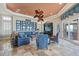 Spacious living room with a decorative ceiling fan, stone floors, and large windows overlooking the water at 2107 4Th Street W Ct, Palmetto, FL 34221