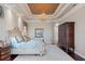 Inviting main bedroom with tray ceilings, decorative chandelier, and ornate bed frame with luxury bedding at 2107 4Th Street W Ct, Palmetto, FL 34221