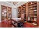 Elegant office with custom built-in bookshelves, hardwood floors, and a rolling ladder at 2107 4Th Street W Ct, Palmetto, FL 34221