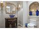 Elegant powder room featuring a unique blue glass vessel sink and ornate mirror at 2107 4Th Street W Ct, Palmetto, FL 34221