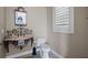 Stylish powder room featuring decorative mirror, stone sink, designer fixtures, and natural light at 2107 4Th Street W Ct, Palmetto, FL 34221