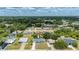Aerial view of a light-blue single-story home in a tranquil residential area with lush greenery and trees at 21480 Eldred Ave, Port Charlotte, FL 33952