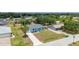 An aerial view showcases the light-blue single-story home with a palm tree in a residential neighborhood at 21480 Eldred Ave, Port Charlotte, FL 33952