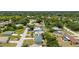 An aerial perspective captures the light-blue single-story home nestled among the trees in a quiet neighborhood at 21480 Eldred Ave, Port Charlotte, FL 33952