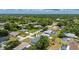 The elevated view highlights the home nestled among the trees in a vibrant and flourishing residential area at 21480 Eldred Ave, Port Charlotte, FL 33952