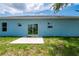 Exterior of the home featuring a patio and sliding glass doors at 21480 Eldred Ave, Port Charlotte, FL 33952