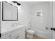 Bright and modern bathroom with vanity, mirror, toilet, and tub with shower at 21480 Eldred Ave, Port Charlotte, FL 33952