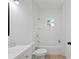 Updated bathroom with a vanity, toilet, and tub with a tiled shower at 21480 Eldred Ave, Port Charlotte, FL 33952