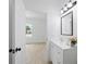 Clean bathroom with vanity, mirror, and view into a bright bedroom at 21480 Eldred Ave, Port Charlotte, FL 33952