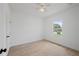 Comfortable bedroom with neutral walls, tile floors, and a sunlit window at 21480 Eldred Ave, Port Charlotte, FL 33952
