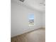 Bright bedroom with wood-look tile floors and natural light from a window at 21480 Eldred Ave, Port Charlotte, FL 33952