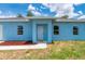 Close-up of a home's exterior, highlighting the front door and landscaping at 21480 Eldred Ave, Port Charlotte, FL 33952