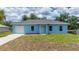 Exterior of the home featuring a well-manicured lawn and a concrete driveway at 21480 Eldred Ave, Port Charlotte, FL 33952