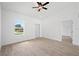 Bright living room featuring wood-look tile floors, fresh white paint and ample natural light at 21480 Eldred Ave, Port Charlotte, FL 33952