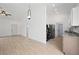 Open-concept living space leading to a modern kitchen with stainless steel appliances at 21480 Eldred Ave, Port Charlotte, FL 33952