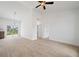 Open living space with light-colored tile floors and sliding glass doors to the outdoors at 21480 Eldred Ave, Port Charlotte, FL 33952