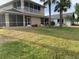 Expansive backyard featuring manicured lawn and screened patio perfect for outdoor living at 224 Boundary Blvd # 224L, Rotonda West, FL 33947